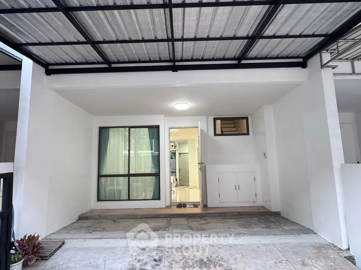 Modern home entrance with covered patio and sliding glass door