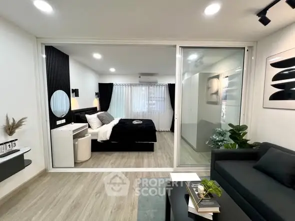 Modern studio apartment with sleek design and cozy bedroom area