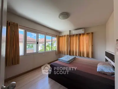 Spacious bedroom with large windows and natural light in modern home