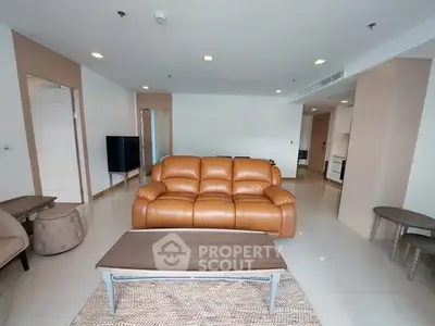 Spacious modern living room with leather sofa and sleek furniture