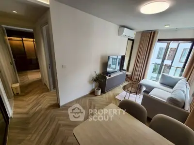 Modern living room with stylish decor and large windows in a contemporary apartment.