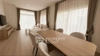 Spacious modern living room with elegant dining area and large windows