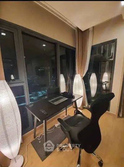 Modern study area with city view, featuring sleek desk and ergonomic chair, ideal for productivity and comfort.