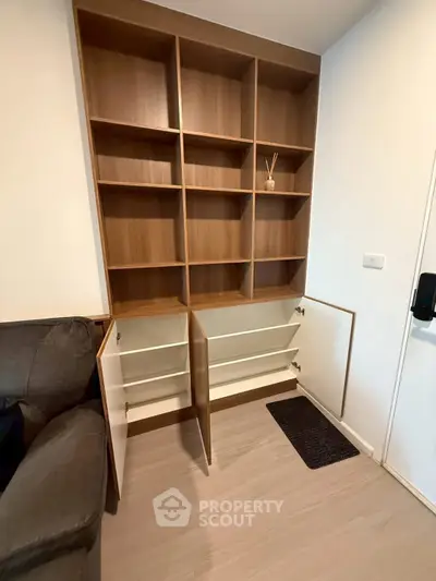 Modern built-in wooden shelving unit with open storage in a cozy living space.