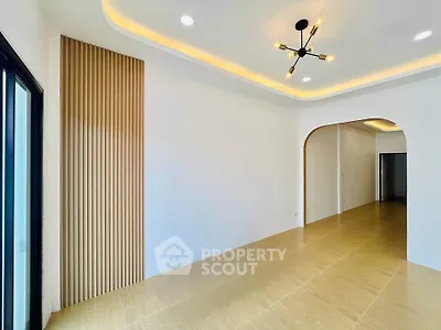 Modern minimalist living room with stylish lighting and wooden flooring