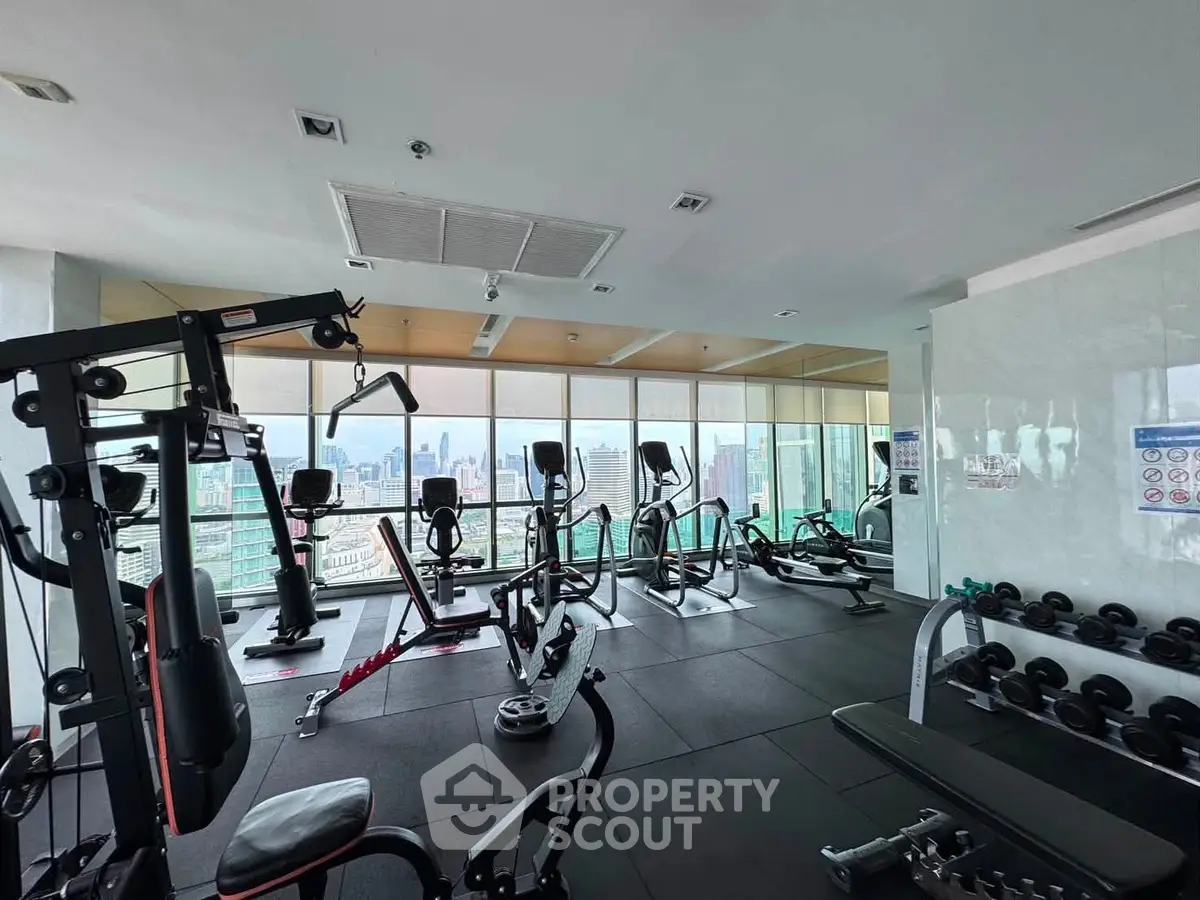 Modern gym with city view in luxury high-rise building