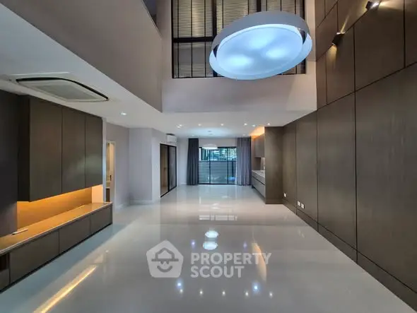 Spacious modern living room with high ceilings and elegant lighting