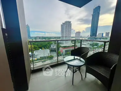Stunning city view from a modern balcony with stylish seating, perfect for relaxation.