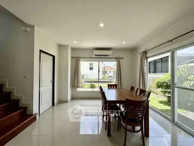 Spacious dining area with large windows and garden view in modern home