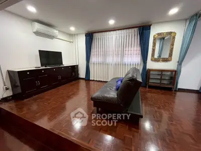 Spacious living room with elegant wooden flooring and modern furnishings