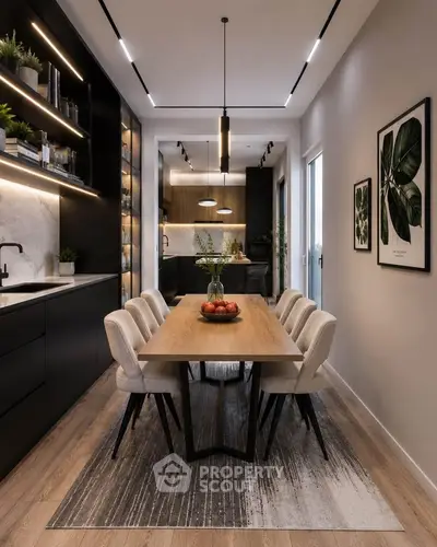 Modern kitchen with sleek black cabinets, wooden dining table, and stylish lighting in a contemporary apartment.