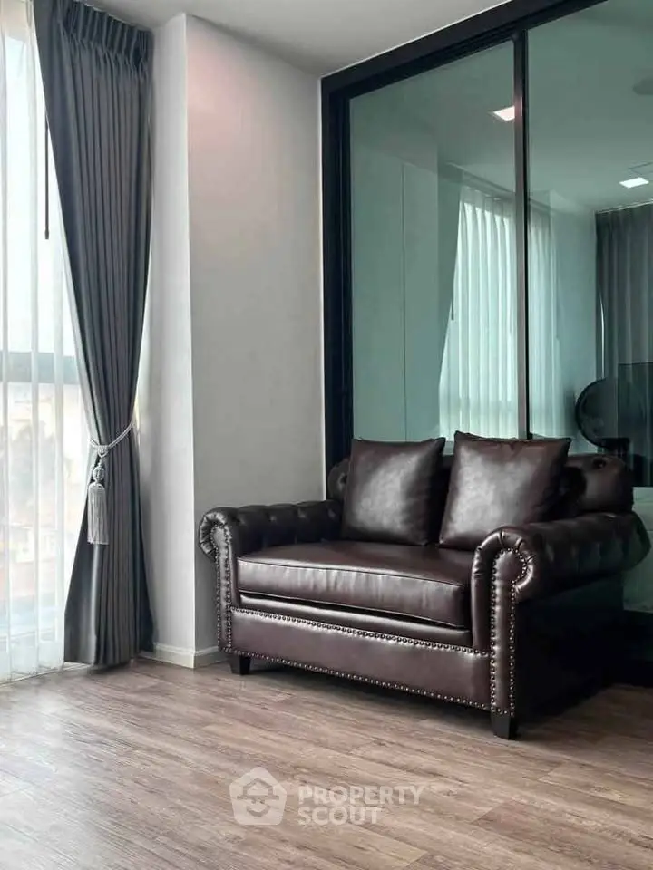 Elegant living room with leather armchair and floor-to-ceiling windows