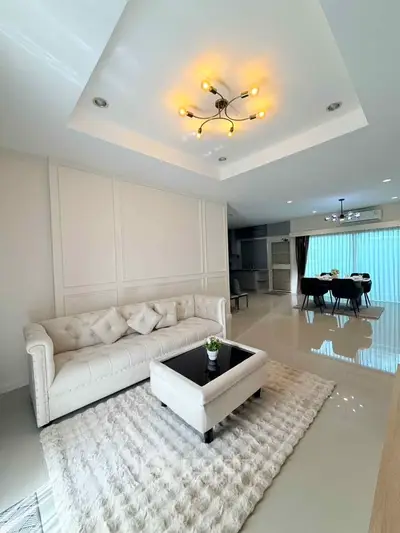 Luxurious modern living room with elegant lighting and plush furnishings, perfect for stylish living.