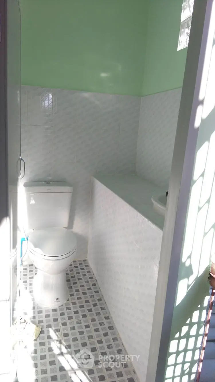 Bright bathroom with modern white tiles and natural light