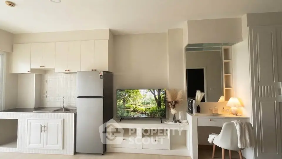 Modern studio apartment with sleek kitchen and cozy living area