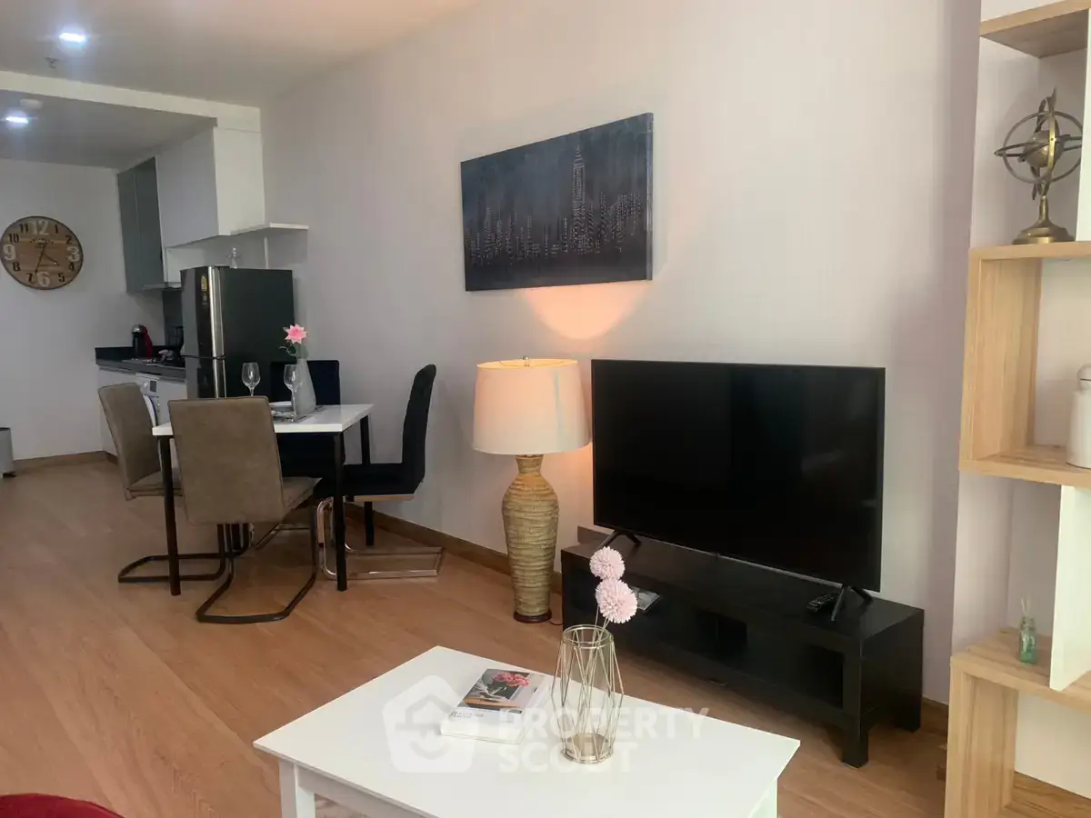 Modern living room with open kitchen, stylish decor, and cozy ambiance.