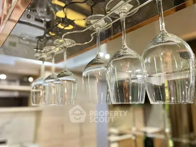 Modern kitchen with hanging wine glasses and sleek design