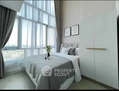 Luxurious bedroom with floor-to-ceiling windows and elegant decor