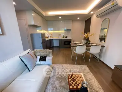 Modern open-plan living room and kitchen with stylish decor and cozy ambiance.