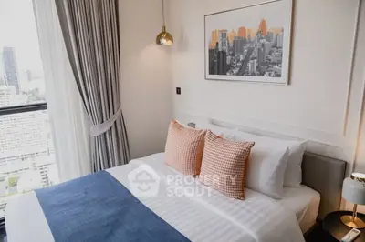 Modern bedroom with city view, stylish decor, and cozy ambiance in high-rise apartment.