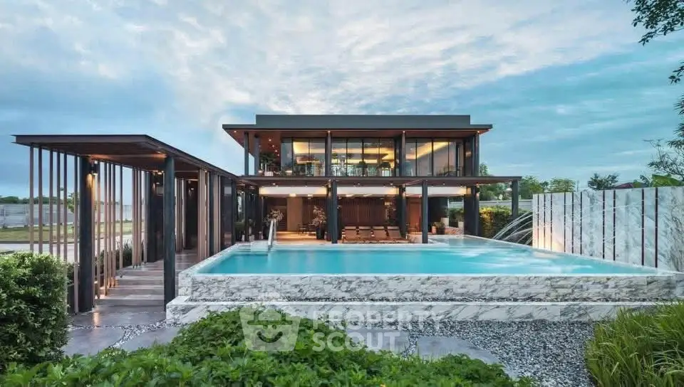 Luxurious modern home with stunning pool and lush garden, perfect for upscale living.