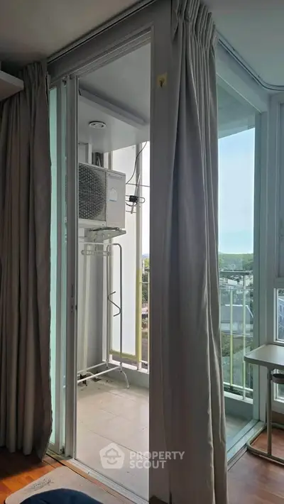 Modern apartment balcony with air conditioning unit and city view