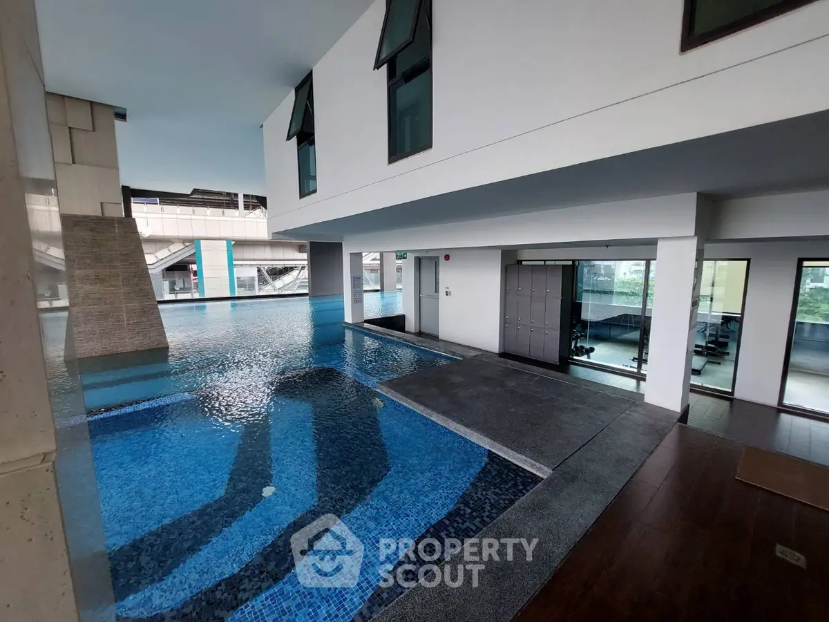 Luxurious indoor pool area with modern architecture and serene ambiance