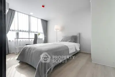 Modern minimalist bedroom with natural light and sleek furnishings