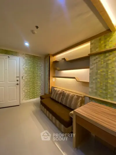 Modern living room with stylish geometric wallpaper and cozy seating area.