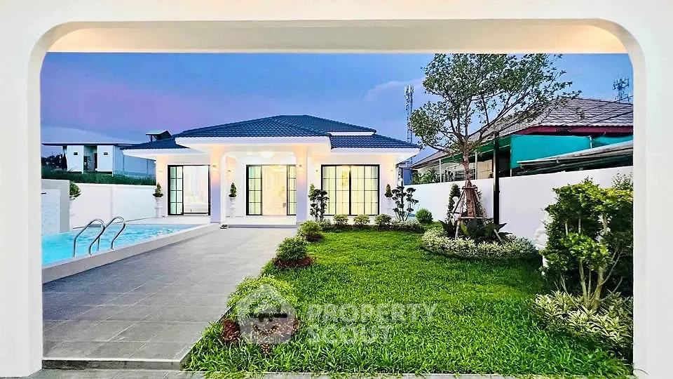 Stunning modern home with lush garden and inviting pool, perfect for luxurious living.