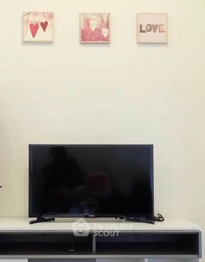 Modern living room with sleek TV setup and stylish wall art