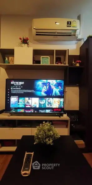 Cozy living room with modern TV setup and air conditioning