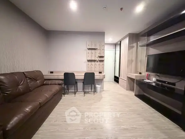 Modern living room with sleek furniture and built-in shelving in a stylish apartment.