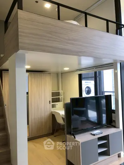 Modern loft apartment with mezzanine, stylish furniture, and natural light.