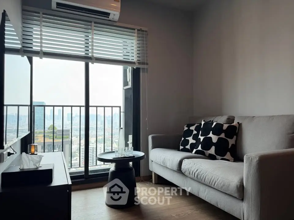 Modern living room with city view, featuring a cozy sofa and stylish decor.
