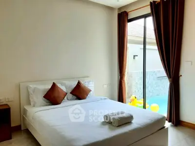 Luxurious bedroom with pool view and elegant decor, perfect for relaxation.