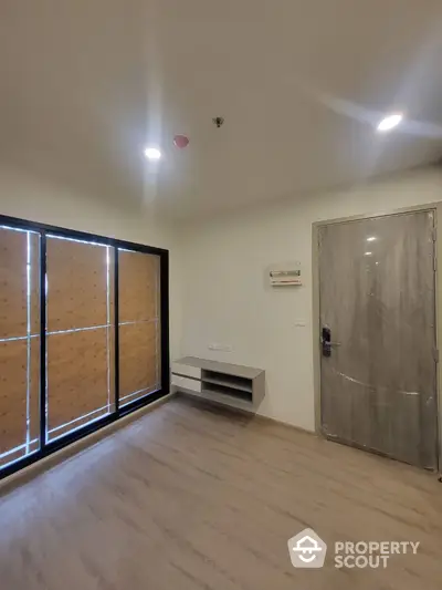 Modern empty room with wooden flooring and large windows