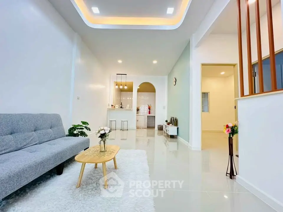 Modern living room with sleek design and cozy ambiance, featuring stylish furniture and elegant lighting.