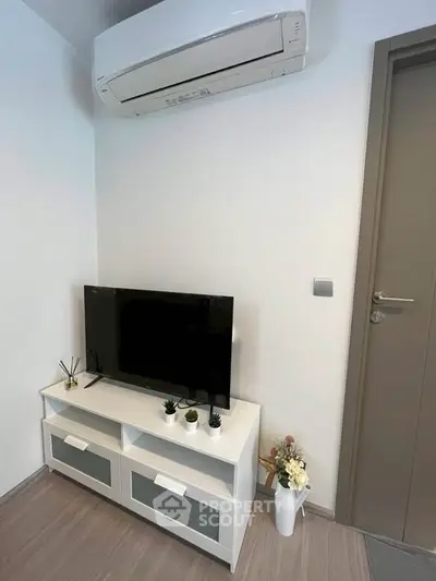 Modern living room corner with TV unit and air conditioning in a stylish apartment.