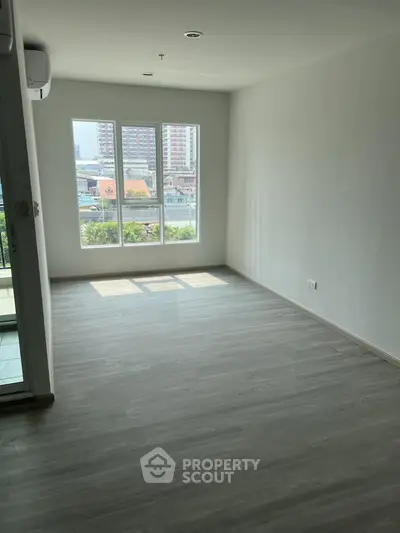 Spacious unfurnished room with large windows and city view, perfect for customization.