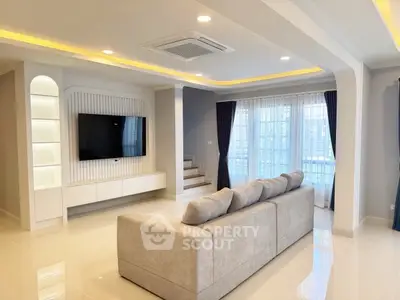 Spacious modern living room with elegant lighting and large sofa, perfect for relaxation and entertainment.