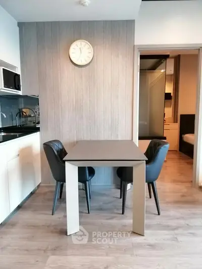 Modern kitchen with dining table and chairs in stylish apartment
