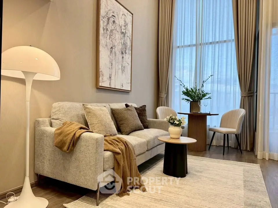 Elegant living room with high ceilings, modern decor, and large windows for natural light.