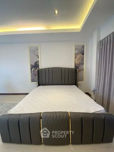 Luxurious bedroom with modern design and elegant decor, featuring a stylish bed and ambient lighting.
