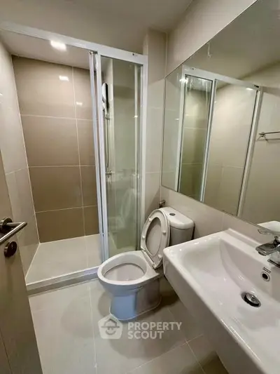 Modern bathroom with sleek shower and elegant fixtures in a contemporary apartment.