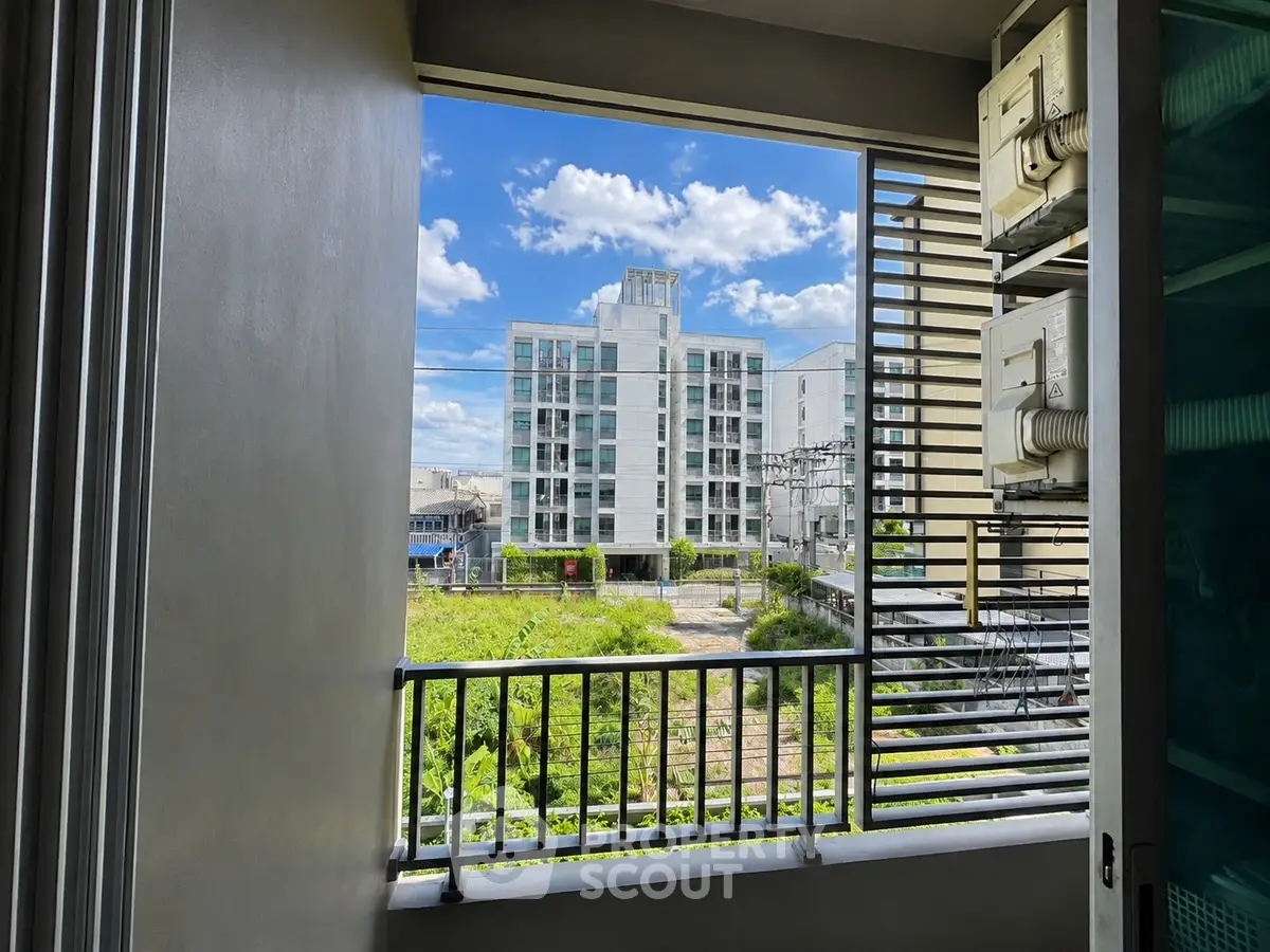 Modern apartment view with lush greenery and clear blue sky
