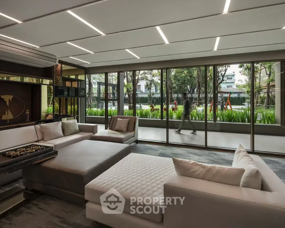 Luxurious modern living room with large windows and garden view