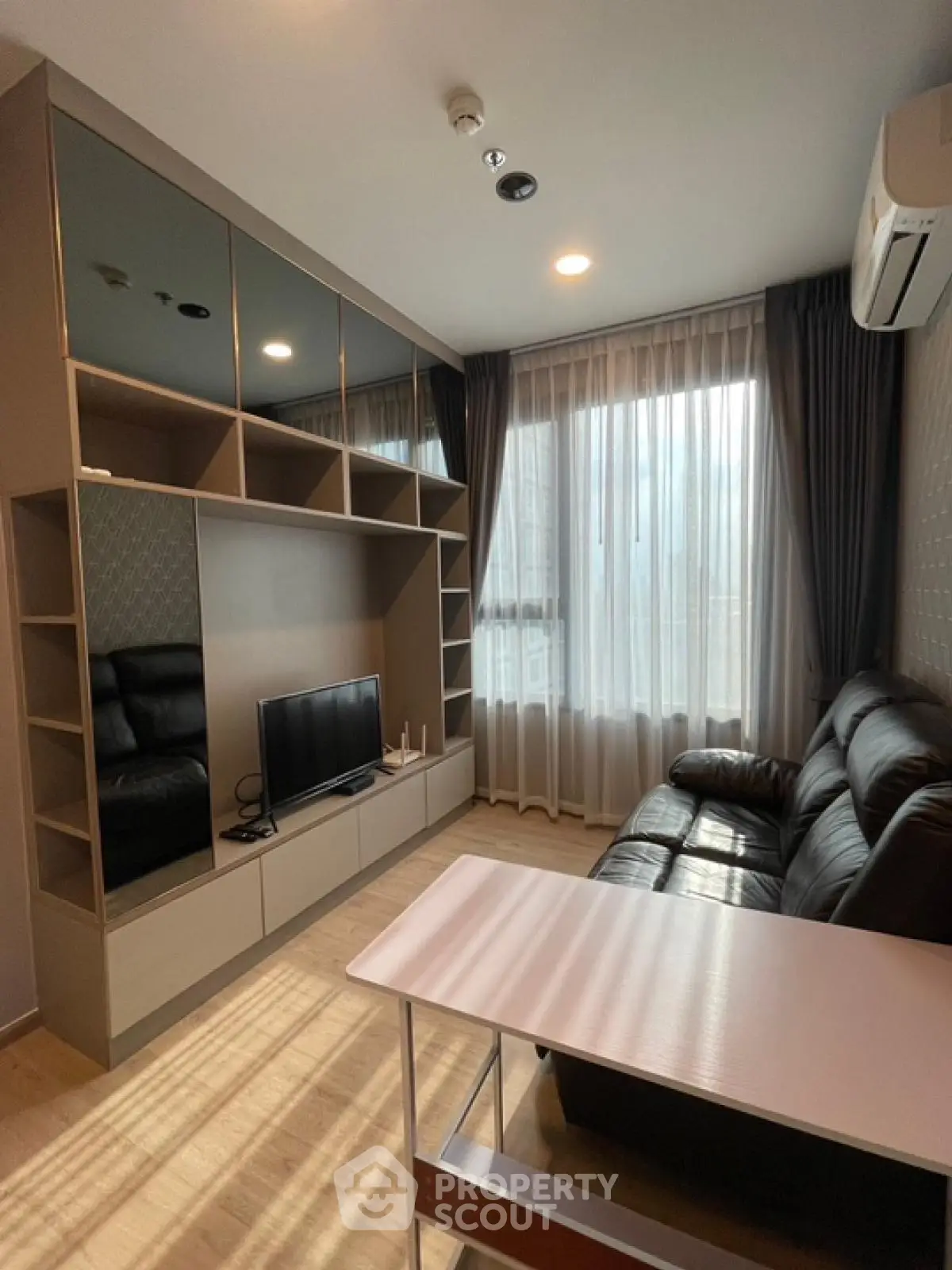 Modern living room with sleek furniture and large window