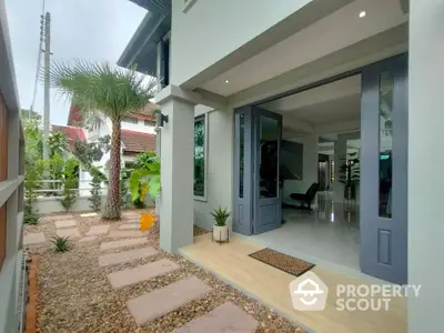 Modern home entrance with stylish landscaping and inviting pathway