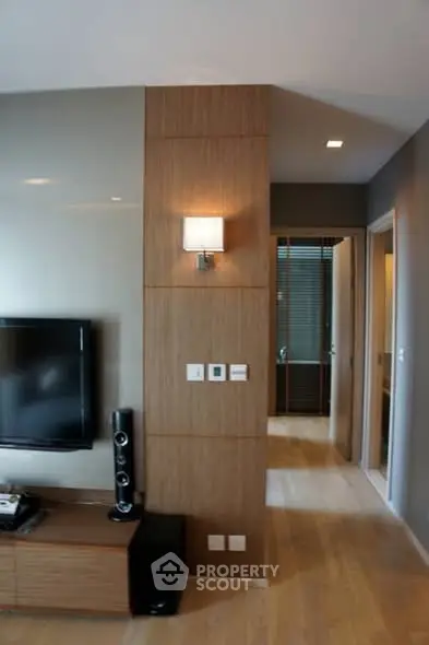 Modern living room with sleek TV setup and stylish lighting